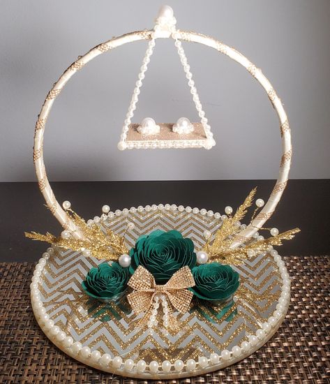 This embellished glass ring holder is the perfect accessory for your wedding/engagement celebrations! Can be used to display his and her rings at an engagement or wedding.  This ring holder features an 8in glass mirror plate with a gold chevron design. The extended hoop is approximately 6in in diameter, and the pearls posts on the swing are designed to accommodate all ring sizes and styles. Rings will not fall off the swing as they will fit onto the posts in an elegant manner. Please message me for customizations. The following customization options are available, free of additional cost: - Rose Color: You may chose up to two rose colors. If you send me an image of your outfit or decor, I can color match. - Use a Plain Mirror Plate as a Base: If you are not a fan of the mirror plate with t Wedding Ring Pillow Diy, Mehndi Decorations, His And Her Rings, Nikkah Wedding, Engagement Ring Holder, Engagement Ring Platter, Wedding Gift Hampers, Cultural Wedding, Engagement Ring Holders