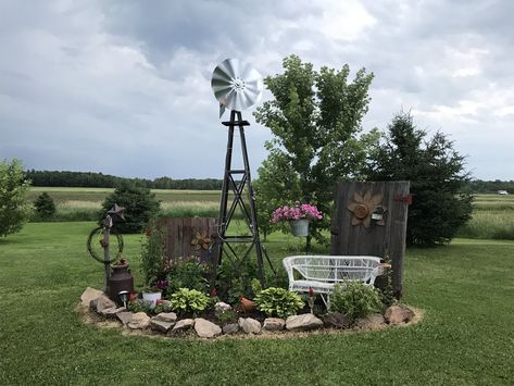 Small Windmill Yard Decor, Decorative Yard Windmills, Landscaping Around Windmill, Rustic Flower Beds In Front Of House Country Decor, Front Yard Landscaping Rustic, Landscaping With Old Farm Equipment, Farm Landscaping Ideas Country Living, Front Yard Landscaping Country, Yard Windmill Garden Art