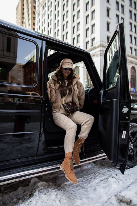 fashion blogger wearing a camel loungewear set from forever 21. this is the perfect look for that beige winter aesthetic. the loungewear set is under $100 and looks so chic with tan combat boots. to recreate this edgy winter outfit, click through to my fashion blog. #loungewear #casualoutfit #winteroutfit #beige Tan Combat Boots Outfit, Beige Combat Boots Outfit, Chanel Combat Boots, Airport Outfit Winter, Tan Combat Boots, Black Shearling Jacket, Combat Boot Outfits, Combat Boot Outfit, Mia Mia Mine