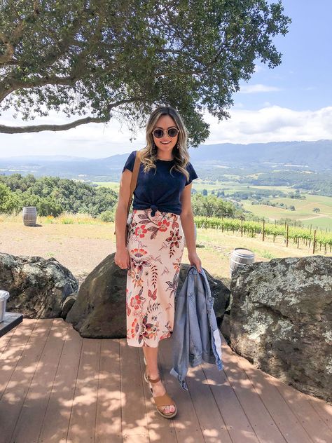 Fashion and beauty blogger Jessica Sturdy of Bows & Sequins at Kunde Winery in Napa / Sonoma California wearing a tied tee shirt, floral print silk midi skirt, espadrille sandals, and a denim jacket. Sonoma Outfits, Wine Tasting Outfit Summer, Napa Outfit, Winery Outfit Summer, Wine Tasting Outfit, Camel Sandals, Wineries Outfit, Floral Print Midi Skirt, Sewing Clothing