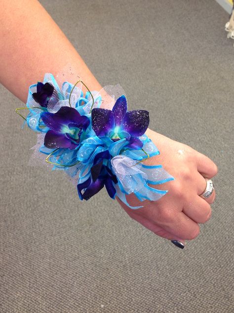 Wrist corsage Blue bomb orchids with silver accents. Purple Turquoise Wedding, Blue Orchid Wedding, Orchid Corsages, Galaxy Wedding, Purple Wedding Bouquets, Orchid Bouquet, Corsage And Boutonniere, Orchid Wedding, Flower Guide