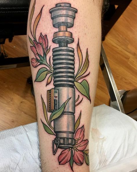 Something similar but with kylo’s saber and forget me nots?? Luke Lightsaber Tattoo, Luke Skywalker Lightsaber Tattoo, Luke Skywalker Tattoo, Star Wars Lightsaber Tattoo, Lightsaber Tattoos, Saber Tattoo, Lightsaber Tattoo, Nerd Tattoos, Nerdy Tattoos