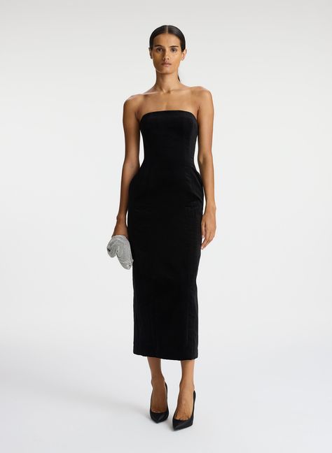 The Elizabeth Dress is crafted of our velvet suiting fabric in timeless black. This softly sculpted midi silhouette features a strapless neckline with bone corsetry and a hook-and-eye panel along the bodice's interior for structure and support. Darted seams enhance the feminine fit as pockets complete the look. We recommend to size up one from your typical size. This style runs small. Shop Dresses Styling Tip: Pair with strappy heeled sandals and a pouch bag for a modern night-out style. Velvet Wedding Guest Dress, Wedding Guest Midi Dresses, Midi Dress Wedding, Casual Work Dress, Floral Velvet Dress, Velvet Wedding, Fall Fashion Dresses, Stunning Bridesmaid Dresses, Black Dresses Classy