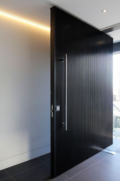 a super elegant black wooden slab door with a large metal handle is a cool and bold idea for a minimalist or conteporary home Pintu Interior, Modern Entrance Door, Contemporary Front Doors, Main Entrance Door Design, Pivot Door, Main Entrance Door, Gate Locks, Contemporary Doors, Entrance Gates Design