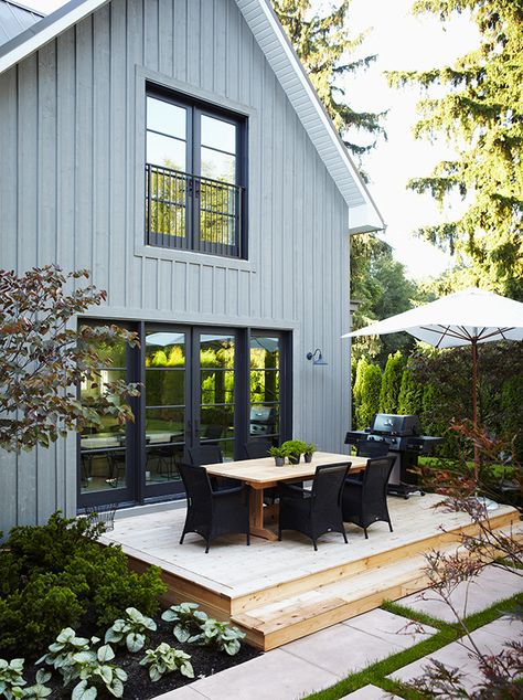 Blue-gray board and batten, black door/window frames, and white soffits, via House and Home. Board And Batten Exterior, Farmhouse Exterior Design, Home Exteriors, Board And Batten Siding, Pintura Exterior, Grey Exterior, Grey Houses, Casa Exterior, Modern Farmhouse Exterior