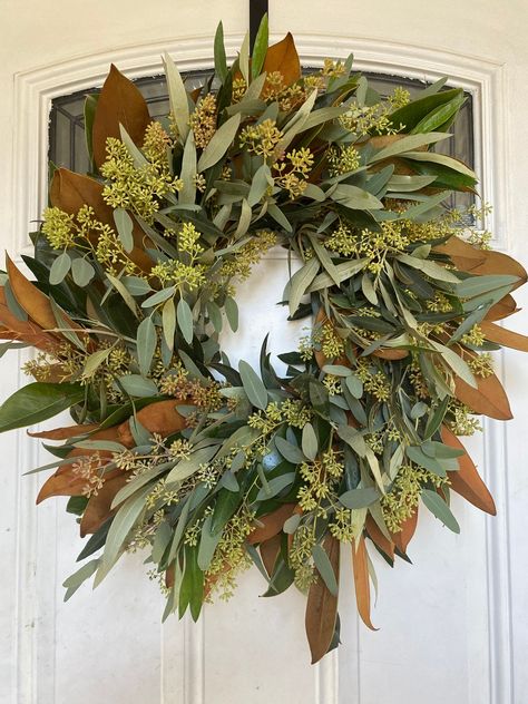 Decorate your home with our fresh magnolia, eucalyptus seeded, and olive wreath. This wreath is used all year long and is a perfect gift for any occasion. It looks beautiful in any home. Don't forget to mist wreath daily and avoid direct sunlight to help wreath last longer. Will usually last about 1-2 weeks if taken proper care. Refunds: For any refunds you must send a credit request within 24 hours of receipt with photos of damage and we will refund you. We will not refund past 24 hours of receipt. Shipping: if ordering for a specific event please put the desired arrival date and the event date in the comments of your purchase. Magnolia Eucalyptus Wreath, Fall Wreath Double Front Door, Fall To Winter Decor Transition, November Porch Decor, Fall Outdoor Wreaths, Minimalist Fall Wreath, Modern Fall Wreaths For Front Door, Wreath Over Fireplace, Thanksgiving Wreaths For Front Door