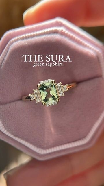 Brianna Trudell on Instagram: "New week, new Sura! This ring features a 1.1 CT unheated radiant green sapphire, set in 14K yellow gold. She will be available on Friday! #rings #engagementring #greensapphire #sapphireengagementring #lavendercreekgems #gemstoneengagementring #artdecoengagementring" The Sura Engagement Ring, Green Sapphire Emerald Cut Engagement Ring, Sapphire Green Engagement Ring, Green Sapphire Engagement Ring Gold, Engagement Rings Green Sapphire, Sura Ring, Green Sapphire Ring Engagement, Rings Engagement Green, Light Green Sapphire Engagement Ring