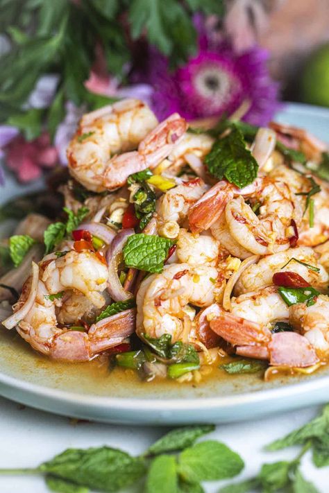 Need a tasty idea for a quick lunch? Try Pla Goong, a spicy Thai shrimp salad full of flavor. It has fresh herbs, big juicy shrimp, and spicy Thai chili peppers. The dressing is tangy and spicy too. Give your taste buds a treat with this yummy salad you'll want to eat again and again! #plagoongrecipe #plagoongingredients #plagoongsaladrecipe #thaishrimpsalad #spicythaishrimpsalad #prawnsaladthai #plagoongsalad Spicy Thai Shrimp, Spicy Shrimp Salad, Thai Shrimp Salad, Thai Chili Peppers, Thai Shrimp, Prawn Salad, Shrimp Salad Recipes, Spicy Salad, Thai Salads