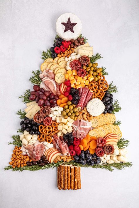 Charcuterie boards have taken the spotlight recently, and with the festive season approaching, why not create a charming Christmas tree charcuterie board for your holiday gathering? This playful and festive board can be crafted to any size you want. Picture an assortment of deliciously sliced meats and cheeses, paired with creamy cheeses, olives, crunchy pretzel sticks, and a colorful mix of fresh fruits and veggies. And you can feel free to add any other treats that tickle your festive fancy! Holiday Cookie Charcuterie Board, Veggie Board Christmas, Holiday Charcuterie Table, Christmas Bring A Board Ideas, Christmas Appetizer Charcuterie Board, Diy Christmas Charcuterie Board, Easy Holiday Charcuterie Board Ideas, Christmas Chauctier Board Ideas, Christmas Sweets Charcuterie Board