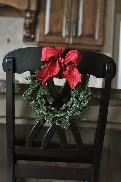 For Christmas this year  I hung wreaths on the back of my bar stools with red ribbon. A simple idea, but it really made a big impact in... Chair Wreaths, Heart Wreaths, Red Farmhouse, Christmas Chair, Chair Decor, Small Wreaths, Kitchen Chair, Table Chairs, Burlap Ribbon