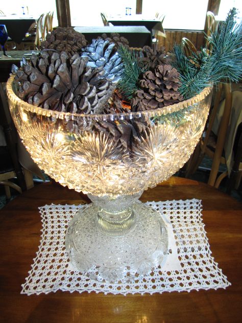 This is a great way to show off a punch bowl that you don't use very often...just fill it with Christmas light strands and decorate on top! Lynne Ludwig, the owner of The Rapids Lodge, put this one together. Punch Bowls Ideas Repurpose, Punch Bowl Repurpose, Decorating With Crystal Bowls, Punch Bowl Decorating Ideas, Hobbit Kitchen, Glass Bowl Decor, Bowl Ideas, Crystal Bowl, Punch Bowls