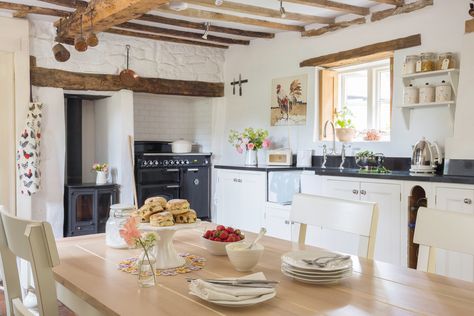 Complete with wood-burning stove and classic rangecooker, is this the quintessential cottage kitchen? We certainly think so. #cottage #thatchedcottage #smallspaces #livingroom #cottagekitchen #kitcheninspiration #cottagedecorating #cottageinspiration Cottage Homes Interior Kitchens, Small Cottage Homes Interior, Cottage Homes Interior, White Kitchen Traditional, Small Kitchen Cabinets, Period Living, Small Cottage Homes, Traditional Kitchen Design, Cottage Renovation