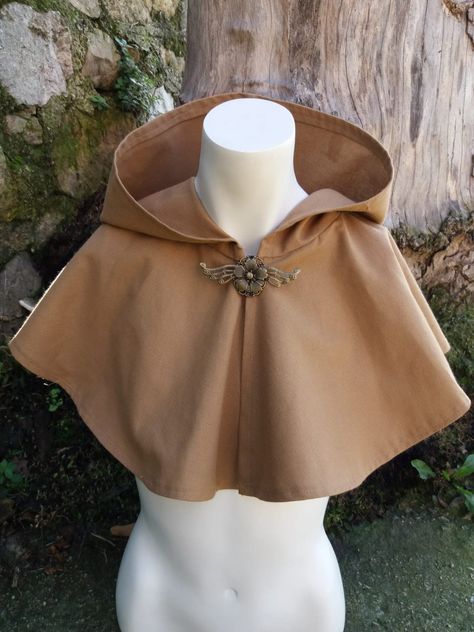 BROWN HOOD WITH MANTLE Cape brown hooded cloak, medieval fantasy costume cape with hood. Fabric with front opening and top closure. Round neck and wide and long hood finishing at the waist. These piece are unique, original and handmade by me. We only sell on ETSY. Capes And Cloaks, Medieval Hooded Cloak, Cloak Of Many Fashions Dnd, Ren Faire Cape, Unique Clothing Pieces, Cloak Closure, Patchwork Cloak, Traveler Clothes, Moth Fashion