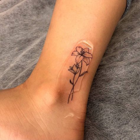 Fine Ankle Tattoo, Lily Flower Tattoos Ankle, Fine Line Flower Tattoo Matching, Lily Flower Line Tattoo, Lily Flower Tattoos Behind Ear, May Lilly Flower Tattoo, Orange Lily Tattoo Small, May Lilly Tattoo, Where To Put A Flower Tattoo