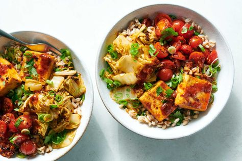 You can use any kind of cooked grain as the base of this colorful, deeply flavored tofu and cabbage bowl The grains, vegetables and tofu add texture, heft and protein, but the real star is the pungent sauce, a mix of chile crisp, garlic and soy sauce sweetened with ketchup Brushed onto the tofu and cabbage before roasting, the sauce caramelizes and mellows Cabbage Rice, Vegan Fish, Grain Bowl, Nyt Cooking, Extra Firm Tofu, Chili Garlic Sauce, Cooking Guide, Fresh Cherries, Bean Curd