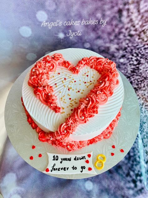 A simple and elegant 10th wedding anniversary cake with flowers in the shape of a heart 💑❤️🌸 Eggless orange fanta flavored cake layered with fresh cream frosting 🍊🎂😋 #Eggless #orangefantacake #freshcream #whippedcream #10thAnniversarycake #freshcream #AngelsCakesBakesbyJyoti 1 Kg Anniversary Cake Design, Heart Shaped Anniversary Cakes, 10 Year Anniversary Cake Ideas, Anniversary Simple Cake, Cute Anniversary Cake Ideas Simple, Heart Shape Cake Designs For Anniversary, Happy Anniversary Cake Design, Easy Anniversary Cake, 10 Anniversary Cake