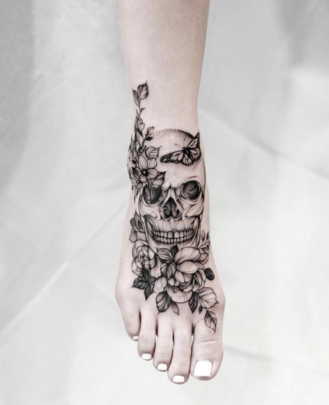 Skull And Magnolia Tattoo, Forearm Tattoo Feminine, Skull Ankle Tattoo, Hand Finger Tattoos For Women, Half Skull Half Flower Tattoo, Foot Cover Up Tattoos For Women, Skull Tattoo Thigh, Skull Foot Tattoo, Foot And Ankle Tattoos For Women