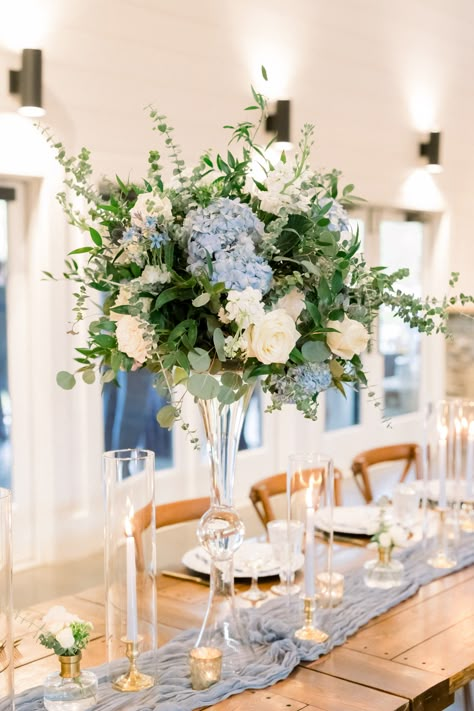 Hydrangea And Candle Centerpiece Wedding, Blue Wedding Flower Centerpieces, Tall Blue And White Wedding Centerpieces, Dusty Blue Top Table Flowers, Dusty Blue September Wedding, Dusty Blue Vase, Dusty Blue Fall Wedding Table Settings, Steel Blue Wedding Centerpieces, Dusty Blue Rustic Wedding Ceremony Decor