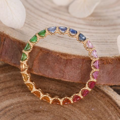 A beautiful gift for Mom, this colorful Scalloped Pave Rainbow Sapphire Eternity Band is a true celebration of family. The full eternity rainbow sapphire band is designed with beaded decor & scalloped pave, making the Eternity Ring in Rainbow Sapphire stronger & suitable for everday wear. ◆ Product Specifications ※18K Rose gold ※Rainbow Color Natural Sapphire, 2.0mm Round Cut ※Setting: Scalloped Prong ※Made in the USA ★Procedure information Please select the style, material, and size from the dr Rainbow Eternity Ring, Rainbow Wedding Ring, Beaded Decor, Sapphire Eternity Band, Sapphire Eternity Ring, Rainbow Ring, Rainbow Sapphires, Rainbow Rings, Sapphire Band