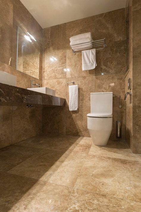 The bathrooms feature marble such as Giallo Antico and Emperador Dark vanities. #marble #gialloantico #emperadordarkvanities #halmannvella Dark Beige Bathroom, Brown Marble Bathroom, Beige And Brown Bathroom, Brown And Beige Bathroom, Beige Marble Bathroom, Brown Tile Bathroom, Cosy Bathroom, Bathroom Things, Brown Tile