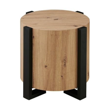 Meet your new favorite sidekick, the Steve Silver Darcie faux-wood end table. This sleek piece brings a mix of modern and architectural flair to any chair or living room area with its' natural looking wood finish and black iron legs. With clean lines and a 24-inch round top, it offers convenient and stylish support without those pesky corners that always seem to get in the way. Its flowing yet assertive profile adds just the right touch of personality to any space. Elevate your room with the Dar Unique End Tables, Round Wood Table, Wood End Table, Living Room Area, Living Room Side Table, Wood End Tables, Living Room End Tables, Wood Rounds, Round Top