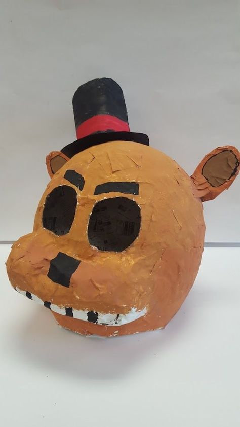 This paper mache mask was created by a 14 year old male student. He created this mask based on a character he like from Five Nights at Freddies. They started with a large Balloon and created the hat from paper. Hat From Paper, Paper Mache Mask, Large Balloons, Masks Art, A Character, Five Night, Bobble Head, Five Nights At Freddy's, Paper Mache