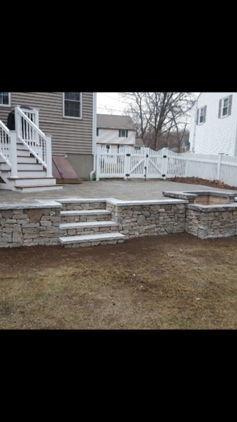 Elevated Patio With Retaining Wall, Patio With Retaining Wall And Steps, Elevated Patio Ideas, Back Porch Steps Down To Patio, Step Down Patio Ideas, Raised Patio Ideas Retaining Walls, Steps Down To Patio, Patio With Steps Down From House, Raised Concrete Patio