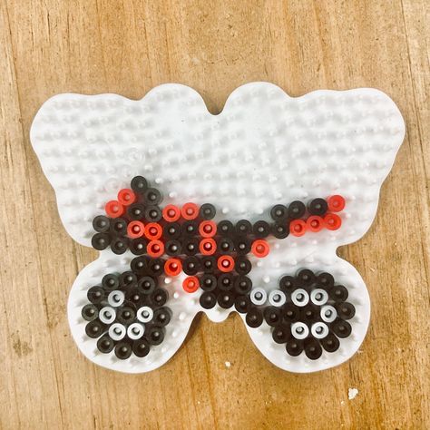 Motorcycle pattern on a butterfly hama bead board. 🏍 #hamabeads #motorcycle #motorbike #butterfly Perler Bead Motorcycle, Hama Beads Patterns Butterfly, Motorcycle Perler Beads, Peeler Bead Keychain, Motorcycle Pixel Art, Melting Beads Patterns, Cute Hama Bead Ideas, Art Perler Beads, Perler Beads Ideas