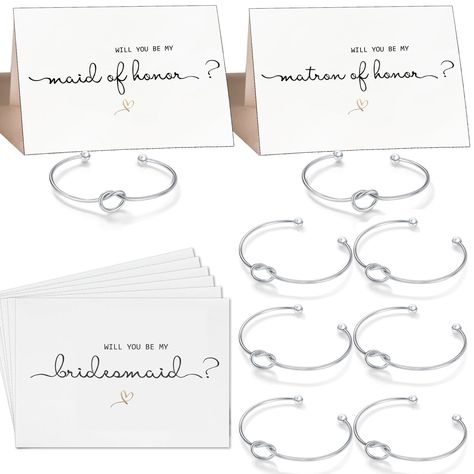 PRICES MAY VARY. When you need to ask your girls to be by your side these gifts are just the thing! BRIDESMAID GIFT SET: 1 x will you be my maid of honor card + 1 x will you be my Matron of honor card + 6 x will you be my bridesmaid cards + 8 x silver tone bridesmaid bracelets. Made from quality 300sgm white card size: 6 x 4 in. Adjustable "Tie The Knot" Bracelet size: 2.7 in. CUSTOM PROPOSAL: All bridesmaid proposal cards are blank on the inside invite your favorite people to be your bridesmaid Bridesmaid Bracelets, Maid Of Honor Card, Be My Bridesmaid Card, Bridesmaids Gift Sets, Asking Bridesmaids, Bridesmaid Card, Gifts Set, Be My Bridesmaid Cards, Bridesmaid Proposal Cards