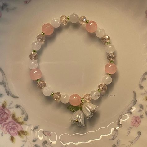 my lily of the valley bracelet 🪷 . . . . . . . . . . . #explore #explorepage #jewelry #beadwork #beads #beadsoup #charms #bracelets #etsy #etsyfinds #beadjewelry #beadbracelets #coquette #coquetteaesthetic #coquettefashion #coquettegirl #pastelaesthetic #lilyofthevalley #beadsbracelet #flowers Cute Bracelets Ideas Beads, Coquette Bracelets, Coquette Bracelet, Lily Bracelet, Bff Bracelets, Bracelets Etsy, Gelang Manik-manik, Bracelet Inspo, Beads Craft Jewelry