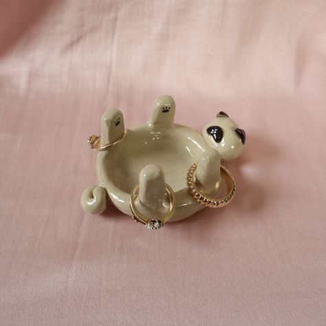 Pug jewellery holder/trinket dish. Handmade using air dry clay, painted and topped with a shiny varnish.  All products are unique and handmade by myself. Made with care and a special attention to detail ✨ Please note - since each product is hand crafted and hand painted, there may be small imperfections that make each piece unique and special.  💧Water resistant but not waterproof 💧 Clay Air Dry Diy, Clay Pottery Jewelry Holder, Practical Air Dry Clay Projects, Clay Art Useful, Useable Clay Projects, Easy Clay Jewelry Dish, Usable Clay Projects, Ceramic Art Jewelry Holder, Pinch Pot Jewelry Holder