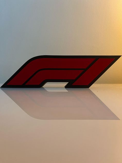 Rev up your decor with this stunning F1 logo sign! 🏎️🏁 Perfect for motorsport enthusiasts and Formula 1 fans, this high-quality wall art captures the thrill and excitement of racing. Whether you're creating a stylish man cave or adding a sporty touch to your living space, this F1 logo sign is a must-have. 🏆🎨 Elevate your home decor with a touch of speed and passion! 💥 #F1 #Formula1 #Racing #HomeDecor #GiftIdeas #F1Fan #wallartdecor F1 Themed Gifts, F1 House Decor, F1 Room Decor, F1 Decor, F1 Room, F1 Logo, F1 Merch, Lego Display, Bedroom Ideas Aesthetic