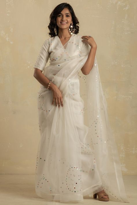 Featuring a pearl white saree in organza base with mirror embroidery. It is paired with a matching chanderi blouse having tie-ups.  FIT: True to size. COMPOSITION: Chanderi, Organza. CARE: Dry clean only. Organza Saree Blouse Designs Latest, White Embroidered Saree, Organza Saree Blouse Designs, White Saree Blouse, Kerala Saree Blouse Designs, Saree Organza, White Embroidered Blouse, Saree Blouse Styles, Mirror Embroidery