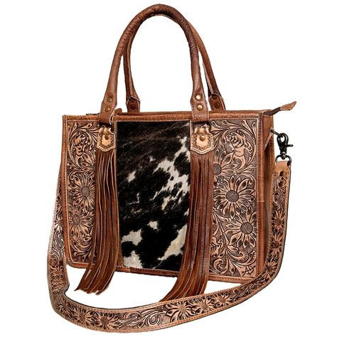 PRICES MAY VARY. Designer Handbag Purse: Elevate your style with this exquisite women's fashion purse, featuring intricate handbag that embodies the spirit of artisan design with a touch of Western flair. Premium Materials: Crafted from high-quality cowhide with embossed accents and stylish fringes, this luxury leather handbag is both durable and fashionable, ensuring it stands out in any setting. Spacious and Practical: With ample room for all your essentials, including a convenient interior po Western Bag, Cowhide Purse, Western Handbags, Concealed Carry Purse, Tooled Leather Bag, Tooled Leather Purse, Western Purses, Hand Tooled Leather, Leather Briefcase