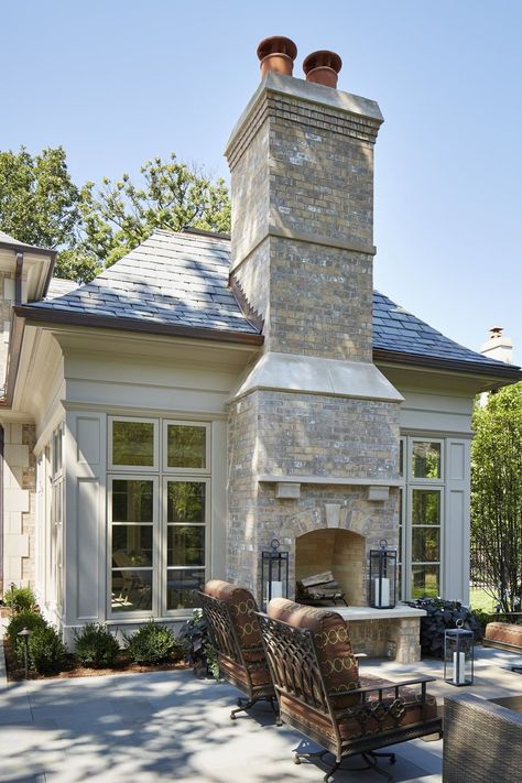 Set between floor-to-ceiling windows, this neutral brick fireplace adds elegance to a welcoming outdoor area from Reynolds Architecture, Design & Construction. #outdoorfireplace #patio #outdoorlounge Outdoor Fireplace Ideas, Transitional Fireplace, Design Fireplace, Outdoor Fireplace Designs, Fire Design, Backyard Fireplace, Outside Living, Fireplace Ideas, Transitional House