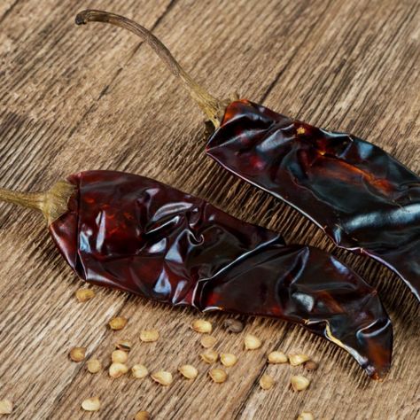 Chile Guajillo is a dried chili pepper used in Mexican cuisine. Learn about this versatile ingredient and how to incorporate it into your recipes. Chili Pepper Recipes, Mexican Sauce, Pepper Recipes, Chile Guajillo, Spice Shop, Peppers Recipes, Deep Red Color, Mexican Dishes, Chili Pepper