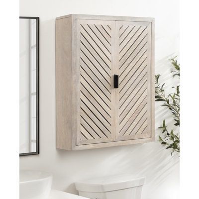 Store bathroom items, cleaning supplies, and other toiletries in this organic modern-inspired bathroom cabinet from Wildon Home®. The Domitilla cabinet has a mango wood composition, constructed in India by artisans, and crafted by hand to give it a one-of-a-kind look and construction. It also features a finish to give it an organic modern look. The chevron arrows and black metal pulls also elevate this minimal modern design to blend into any boho decor. This wall cabinet's overall dimensions are Minimal Modern Design, Bath Cabinet, Wall Mounted Bathroom Cabinets, Door Shoe Organizer, Over Toilet, Cabinet Shelving, Bath Cabinets, Wall Mounted Cabinet, Toilet Storage