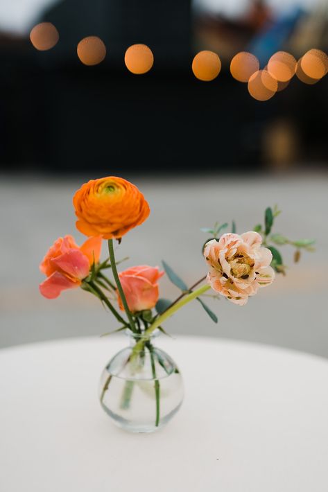 Ranunculus and tulips paired with spray roses. Bud Vases Arrangements, Early Spring Wedding, Bud Vases Flowers, Event Centerpiece, Vase Arrangements, Wedding 2024, Orange Wedding, Peach Wedding, Orange Roses