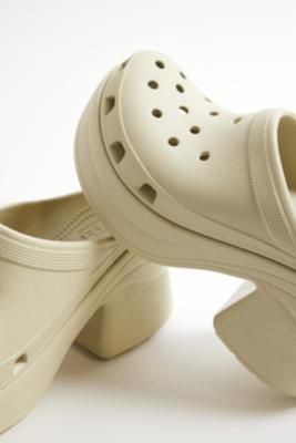 Your favorite Crocs now with a chunky heel. The Crocs Siren features added height while the iconic Crocs Comfort keeps them lightweight, flexible, breathable and buoyant thanks to Iconic Crocs Comfort foam. **Content + Care** \- Rubber \- Wipe clean | Crocs Bone Siren Heeled Clogs - Cream UK 4 at Urban Outfitters Siren Features, Clean Crocs, Heeled Clogs, Clog Heels, Chunky Heel, Chunky Heels, Clogs, Bones, Urban Outfitters