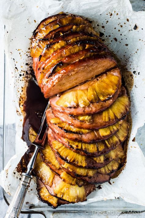 This Modern Honey Pineapple Ham is served in a fresh new way but every bit as delicious as your grandma's traditional ham. It's stuffed with pineapple slices and coated in a balsamic honey glaze then roasted to perfection. It's the perfect Thanksgiving (or Christmas or Easter) main dish recipe.  | theendlessmeal.com Honey Pineapple Ham, Easter Main Dishes, Modern Honey, Pineapple Ham, Roasted Ham, Meat Dinners, Pineapple Slices, Holiday Eating, Perfect Thanksgiving