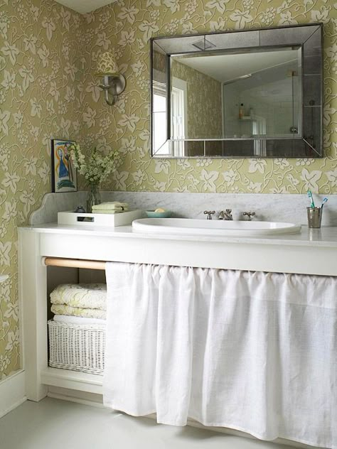 A Classic Approach Give your bath a timeless look by splurging on a marble countertop and save on inexpensive cabinetry. This simple marble-topped workbench-style vanity provides room for towels and toiletries under the sink. Simple cotton skirting, instead of traditional doors, keeps the items under wraps. Flirty green floral wallpaper adds cottage style that's easy to update in the future. Door Curtains Kitchen, Modern Style Decor, Farmhouse Backsplash, Unique Backsplash, Beadboard Backsplash, Kabinet Dapur, Bad Inspiration, Vanity Design, Small Bath