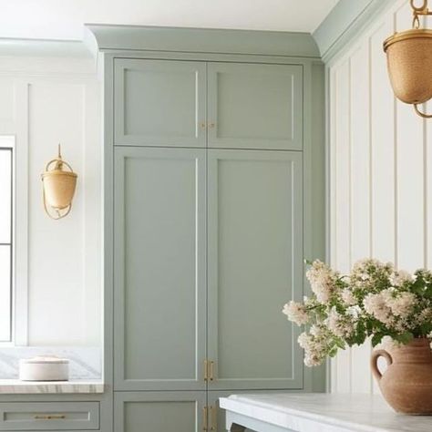 Tamra Lea #Itsahouselovestory on Instagram: "Laundry room design. I love the softness of the look; the creamy white on the wood board and batten with gorgeous shade of soft green/gray paint on the cabinets. The long table in blue-gray and marble contertops, perfect rustic  laundry baskets, multiple but simple verticle windows and the lighting really add beauty and charm to the space.   By @windthekey   •  #itsahouselovestory #windthekey #homedesign #designideas #laundryroom #laundryroommakeover #laundryroomdecor #laundryroomdesign #softpaint #laundryroominspo #laundryroomgoals #interiors #decor #interiordesign #becauseiloveit #loveit #woodfloors" Light Green Laundry Room Cabinets, Two Tone Laundry Room Cabinets, Colored Laundry Room Cabinets, Laundry Room Ideas Green, Light Green Laundry Room, Green Laundry Cabinets, Painted Laundry Room Cabinets, Sage Green Laundry Room, Green Laundry Room Cabinets