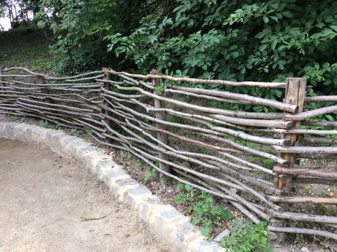 French woven stick fencing Woven Stick Fence, Stick Fences, Stick Fence, Woven Fence, Rustic Garden Fence, Small Scale Gardening, Garden Archway, Garden Gates And Fencing, Garden Organization