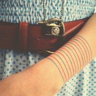 Get a set of blue and red notebook lines. | 32 Cool And Colorful Tattoos That Will Inspire You To Get Inked Tattoo Stripes, Lines Tattoo, Petit Tattoo, Armband Tattoos, Muster Tattoos, Tatuaje A Color, Tattoo Bracelet, Pattern Tattoo, Line Tattoos