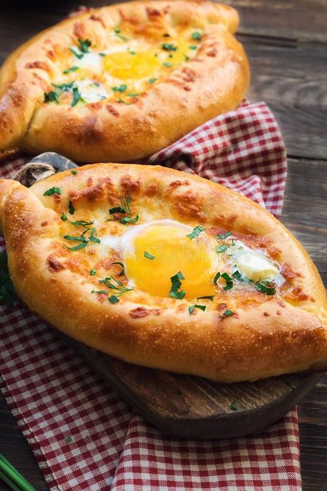 Traditional Egg gondola or Adjarian Khachapuri is a delicious breakfast pizza from Georgia. And one of my family’s favorites. It’s easy and simple to make, and it’s so tasty. This specific kind of khachapuri has a unique shape, looks like a boat filled with gooey cheese filling, baked, then topped with butter and egg, at preference. Egg Boats, Georgian Cuisine, Homemade Spice Blends, Meat Snacks, Second Breakfast, Läcker Mat, What's For Breakfast, Breakfast Pizza, Corn Dogs