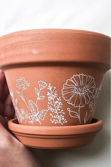 Whether you want to add some decoration to your terracotta pots or you want to transform your planters with a hand painted boho vibe… check out these awesome home DIY painted flower pot ideas for inspiration to make yours perfect! #paintedflowerpot #gardenideas #diy #gardenprojects Gold Terracotta Pots, Terracotta Pot Makeover, White Painted Terra Cotta Pots, Painted Terra Cotta Pots Ideas Simple, Flower Pot Stencil, White Terracotta Pots, Terracotta Pot Decorating Ideas, Boho Plant Pots Diy, Flowerpots Painting Ideas