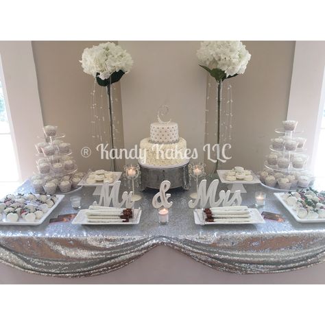 Bridal shower White & silver dessert table 25th Wedding Anniversary Party Ideas Silver Dessert Tables, Silver And White Anniversary Decorations, Anniversary Party Desserts, Black White And Silver Dessert Table, Silver Dessert Table Ideas, 25 Wedding Anniversary Party Ideas Silver, Silver Dessert Table, White Dessert Tables, Bridal Shower White