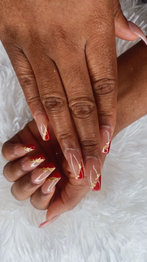 Red coffin nails with a nude base and gold flakes Red And Gold Nails Medium, Elegant Red And Gold Nails, Gold Red And White Nails, Nails That Go With Red Dresses, 49ers Acrylic Nails, Red Ball Nails, Nails With Red Dress What Color, Prom Nails That Go With A Red Dress, Gold Red Bottom Nails