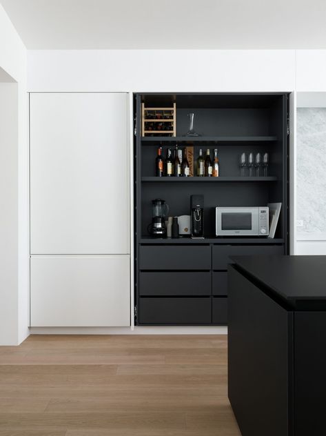 Pocket doors conceal shelving and small appliances in the Noe Valley kitchen of Robert Edmonds and Vivian Lee of Edmonds + Lee Architects. Black Joinery, Black White Kitchen, Ikea Kitchen Design, Hidden Kitchen, Decor Ikea, White Kitchen Design, Ikea Kitchen, Minimalist Kitchen, Pocket Doors