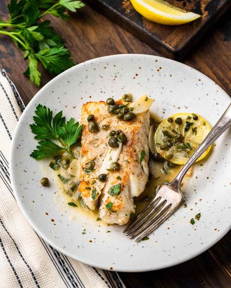 Cod piccata with salty capers, bright lemons, and sliced garlic in a buttery white wine sauce can be ready in about 30 minutes. This cod piccata is simple enough for weeknights but special enough for holidays and gatherings. #codpiccata #fishpiccata #lemoncod Cod Piccata Recipe, Cod Piccata, Sip And Feast, Feast Recipes, Cod Fish Recipes, Piccata Recipe, Seafood Entrees, Italian Favorites, White Wine Sauce